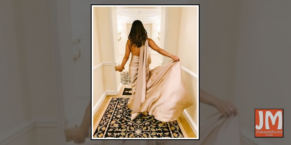 Actress Priyanka Chopra Jonas on Sunday shared her pre-Grammys' party look. Wearing a champagne  satin backless gown, Priyanka is definitely leaving her fans in awe of her fashion statement.