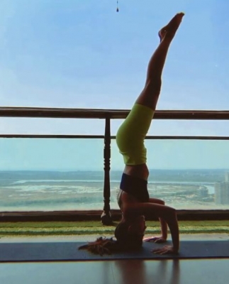 Alaya F pulls off a complicated inversion yoga pose.