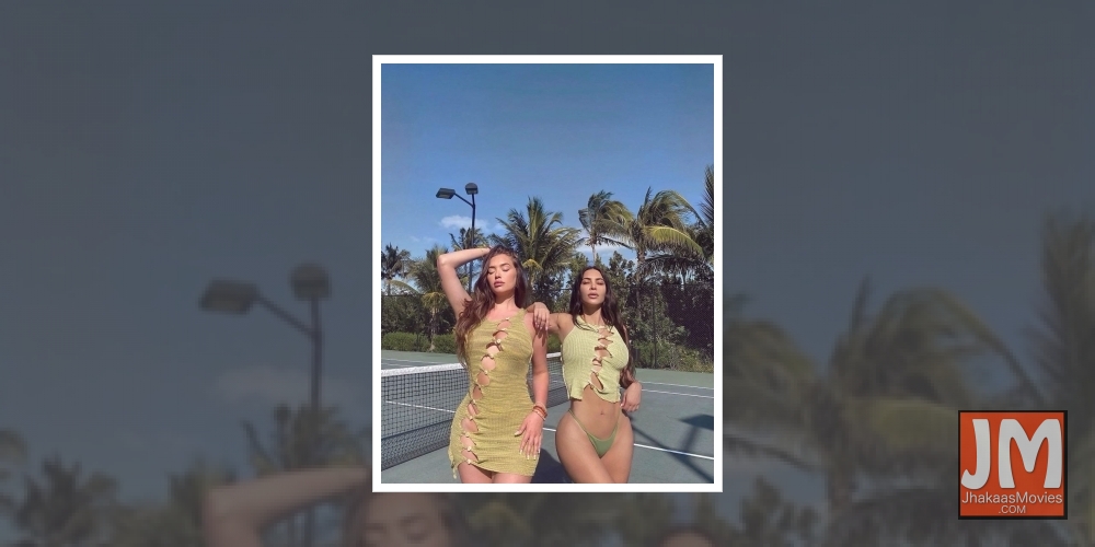 Kim Kardashian slays it in ripped blouse, bikini bottom.