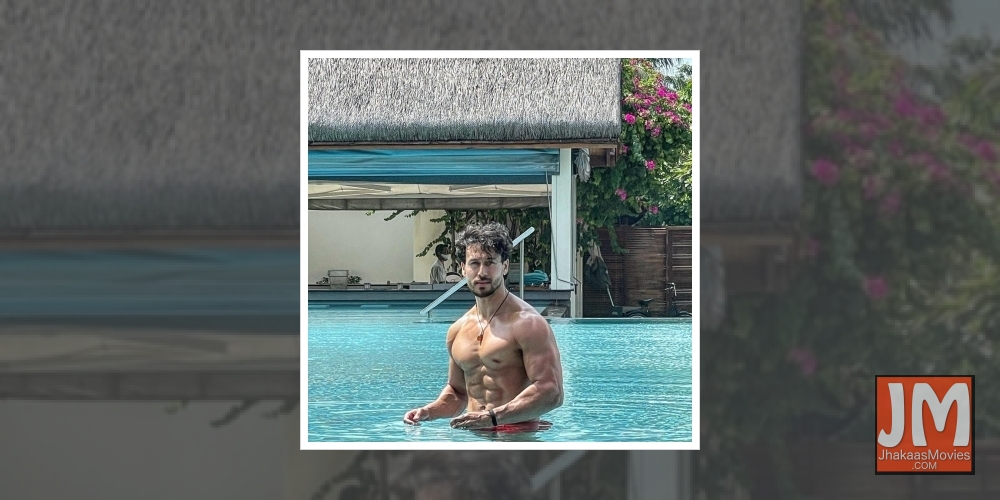 Tiger Shroff flaunts his perfect washboard abs in pool picture.