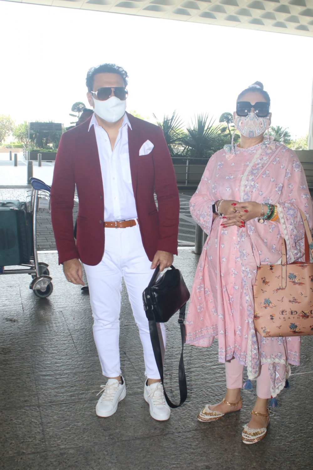 Govinda With Wife Spotted At Airport Departure in Mumbai on 5 May,2021.(Photo: Sanjay Tiwari/IANS)