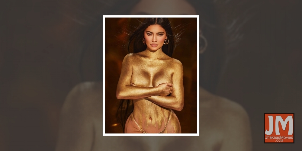 Kylie Jenner shimmers in gold dust body painted photo.