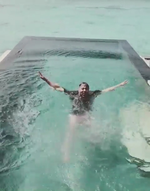 Rapper Badshah has shared a hilarious video of him waking up to the tunes of "Paagal". The rapper took to Instagram on Monday, where he is seen getting woken up by his alarm and then all of a sudden straight jumping out of the window into the infinity pool to get rid of sleepiness.