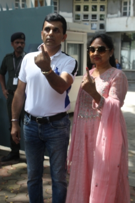 Mumbai: Filmmaker Anand Pandit shows his inked finger after casting his vote for the Maharashtra Assembly elections, in Mumbai on Oct 21, 2019. (Photo: IANS)