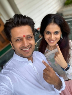 Mumbai: Ritesh Deshmukh with his wife Genelia after casting their vote for Maharashtra assembly elections in Mumbai on Oct. 21, 2019. (Photo: IANS)