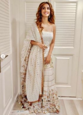 Actress Disha Patani chose a pristine white ensemble for the mahurat puja of her upcoming film 