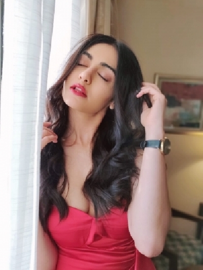 Bollywood actress Adah Sharma looked hot in a stunning red off shoulder gown. Adah looked stunning in a bright red off shoulder gown with a thigh high slit.