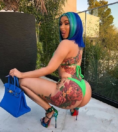 Cardi B flaunts massive colourful back tattoo.
