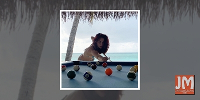 Elli AvrRam plays pool in bikini by the beach